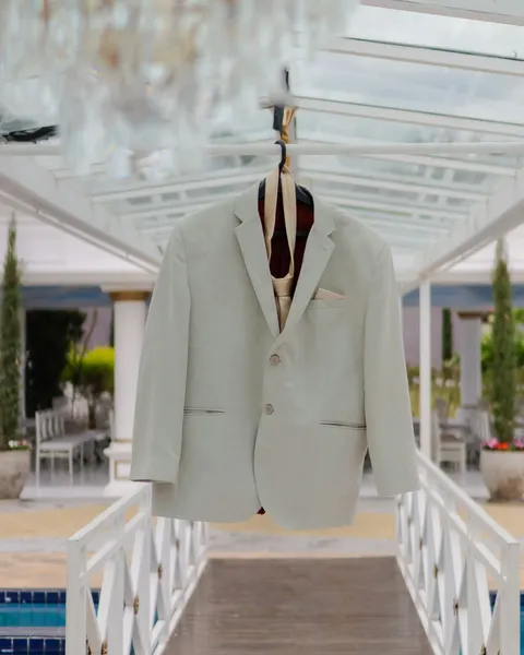 A light grey blazer on a hanger